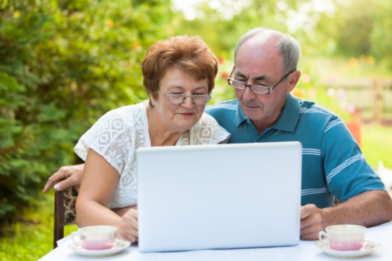 Image of a senior couple looking at a computer